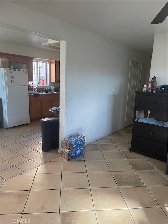 kitchen featuring white refrigerator and light tile patterned flooring