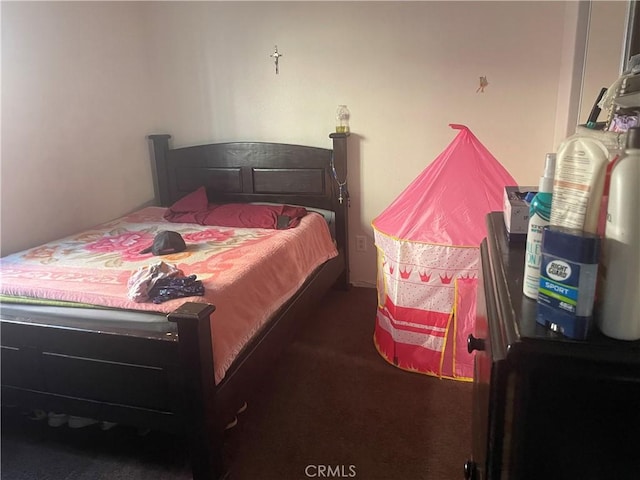 bedroom featuring dark colored carpet