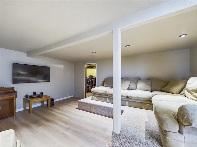 living room with beamed ceiling and light hardwood / wood-style flooring