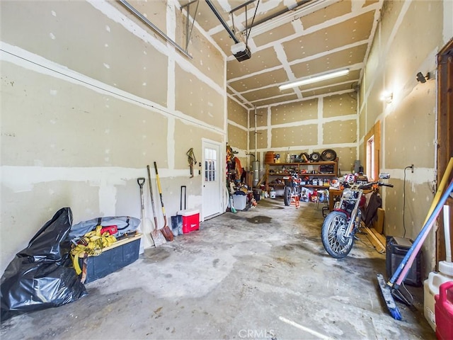 garage with a workshop area and a garage door opener