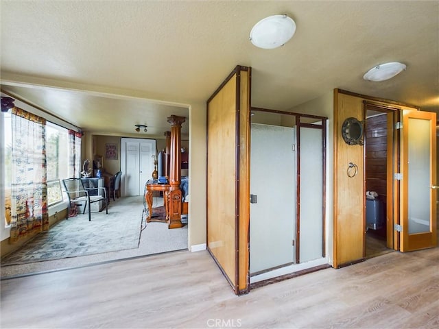 interior space featuring light hardwood / wood-style floors and a textured ceiling