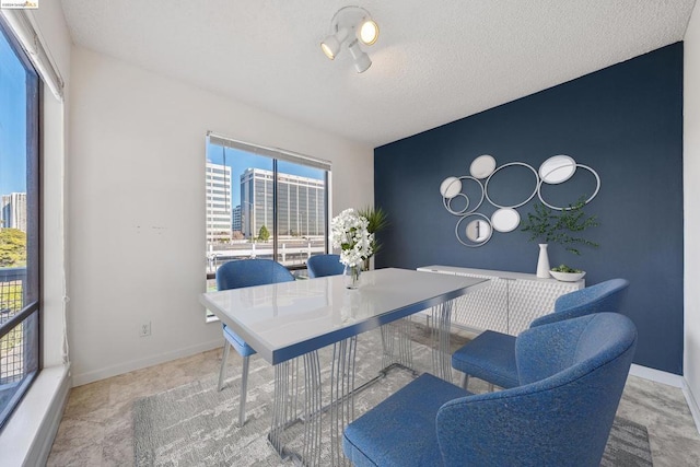 dining area featuring a textured ceiling