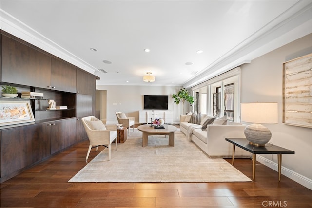 living room featuring crown molding and dark hardwood / wood-style flooring