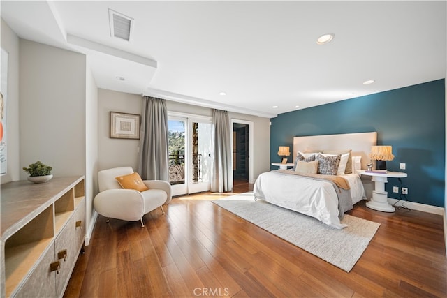 bedroom featuring access to outside, french doors, and hardwood / wood-style flooring