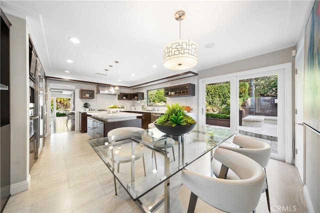 tiled dining area with ornamental molding and a healthy amount of sunlight