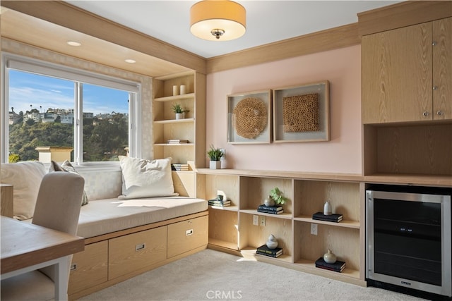 sitting room featuring beverage cooler and light colored carpet