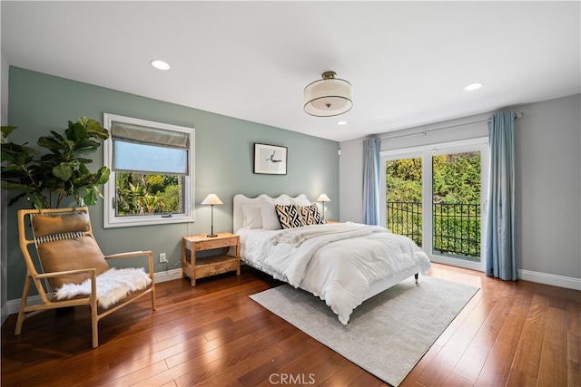 bedroom featuring dark hardwood / wood-style flooring and access to exterior