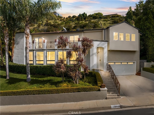 view of front of home featuring a balcony and a garage