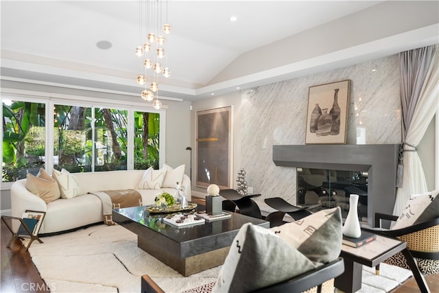 living room featuring vaulted ceiling, hardwood / wood-style flooring, and a fireplace