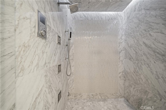 bathroom with a tile shower