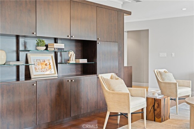 sitting room featuring light hardwood / wood-style flooring and crown molding