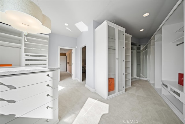 spacious closet featuring light carpet