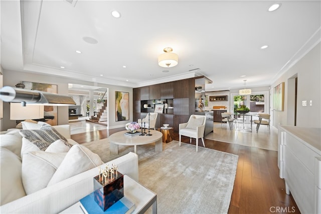 living room featuring light wood-type flooring and crown molding