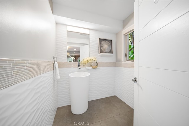 bathroom with tile walls and tile patterned floors