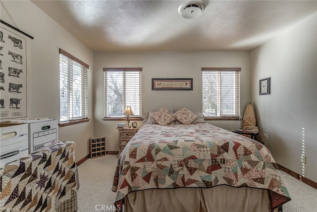 carpeted bedroom featuring a textured ceiling