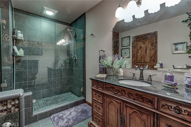 bathroom with vanity, tile patterned flooring, and a shower with door