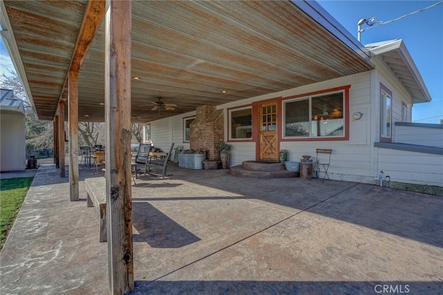 exterior space with ceiling fan and a patio area