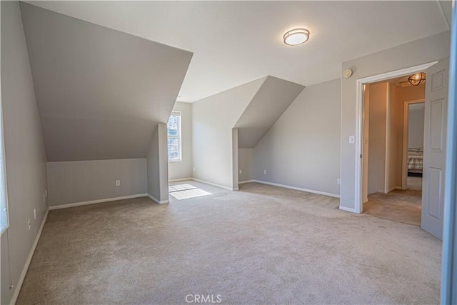 additional living space with light colored carpet and lofted ceiling