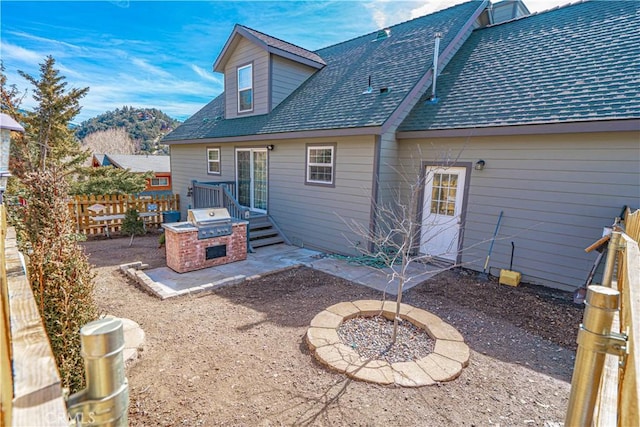 rear view of house with a fire pit, area for grilling, and a patio