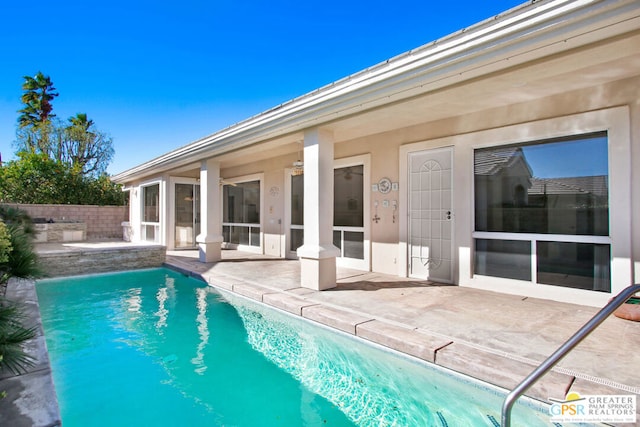 view of pool with a patio area and ceiling fan