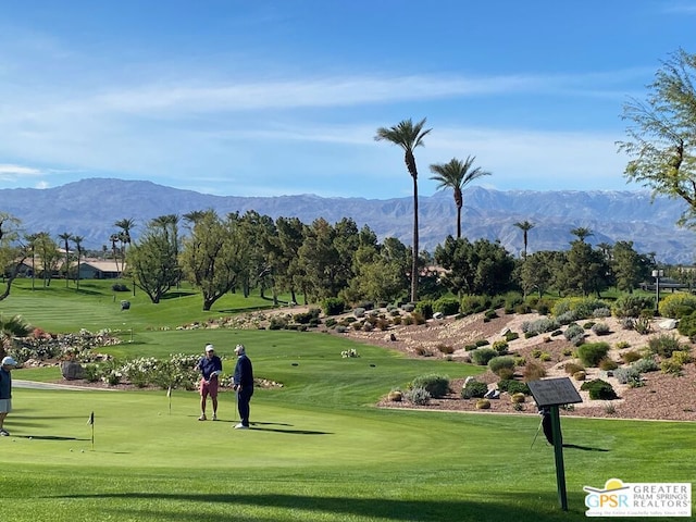 view of community featuring a yard and a mountain view