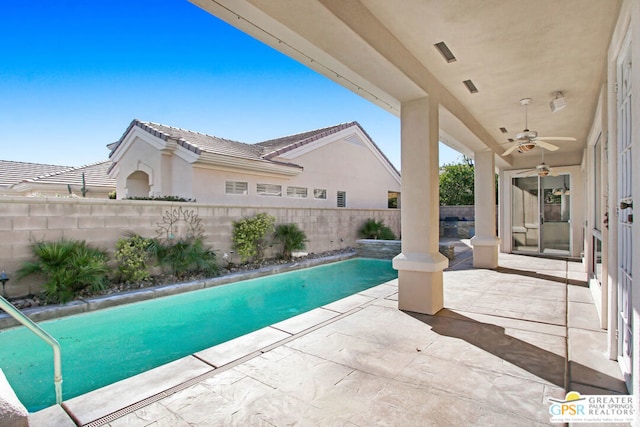 view of swimming pool featuring a patio and ceiling fan