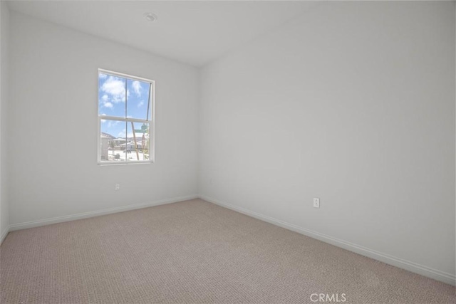 unfurnished room featuring light colored carpet