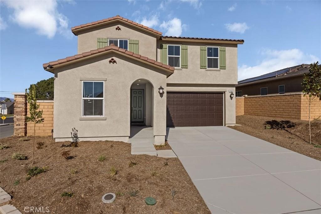 mediterranean / spanish home featuring a garage