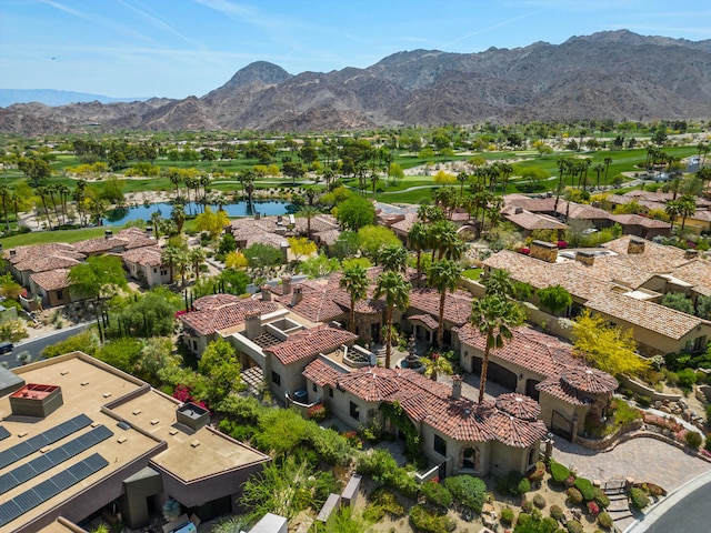 birds eye view of property with a water and mountain view