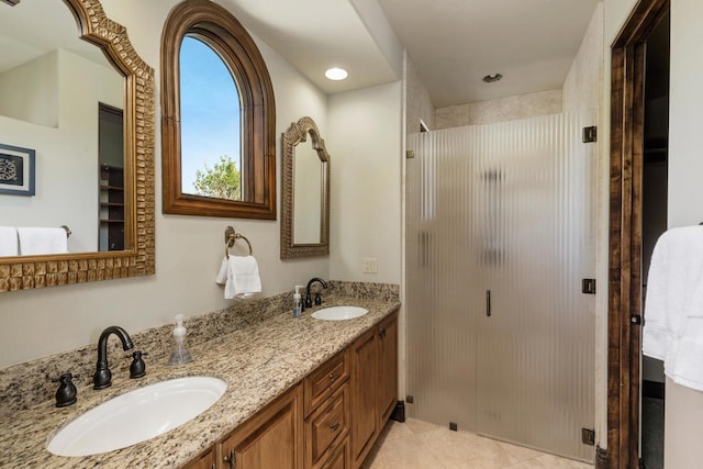 bathroom featuring vanity, tile patterned flooring, and walk in shower