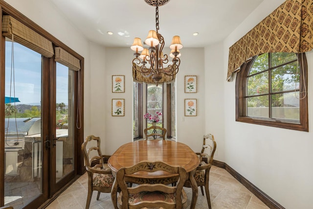 dining space with an inviting chandelier