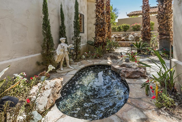 view of pool with a small pond