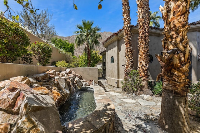 exterior space with pool water feature