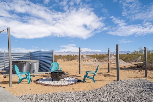 view of jungle gym with a mountain view and a fire pit