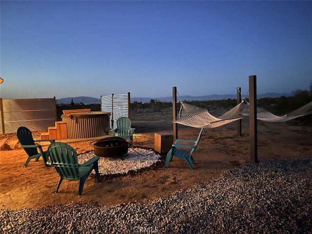 exterior space with an outdoor fire pit and a mountain view