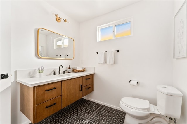 bathroom featuring toilet, vanity, and tile patterned floors