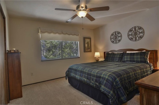 bedroom featuring ceiling fan and light carpet