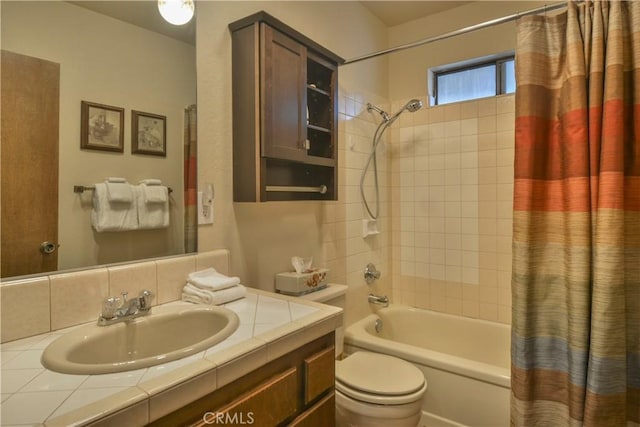 full bathroom with vanity, shower / bath combination with curtain, and toilet