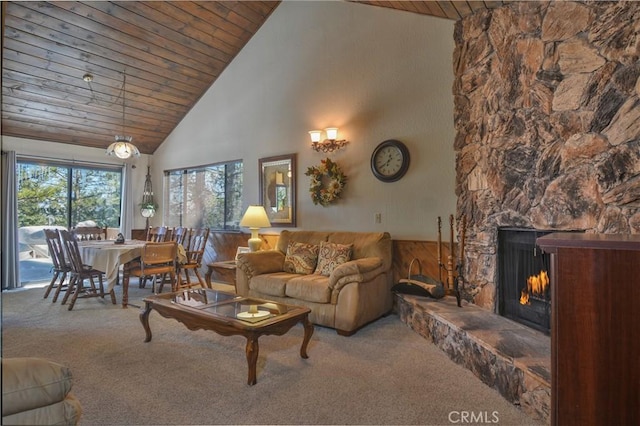 living room with wood ceiling, a fireplace, high vaulted ceiling, and carpet