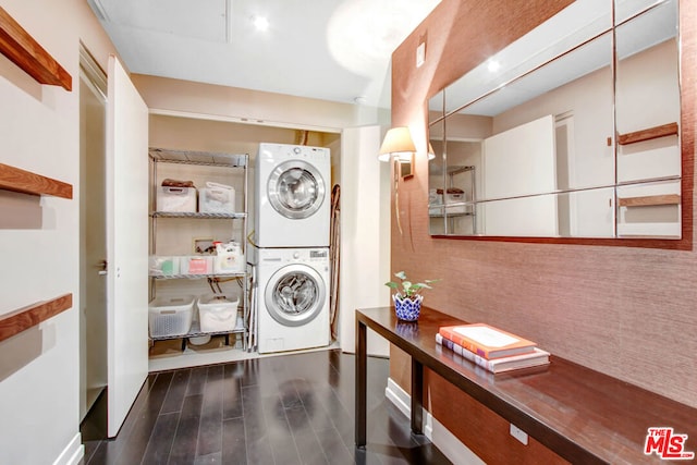 clothes washing area featuring stacked washer and clothes dryer and dark hardwood / wood-style flooring