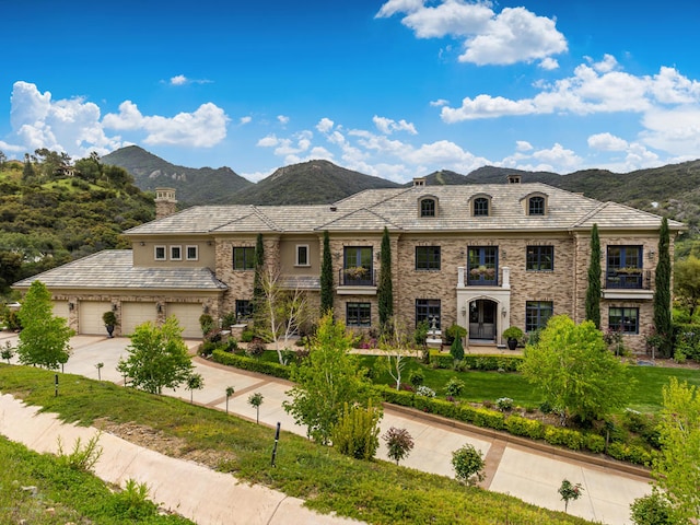 view of front facade featuring a mountain view and a garage