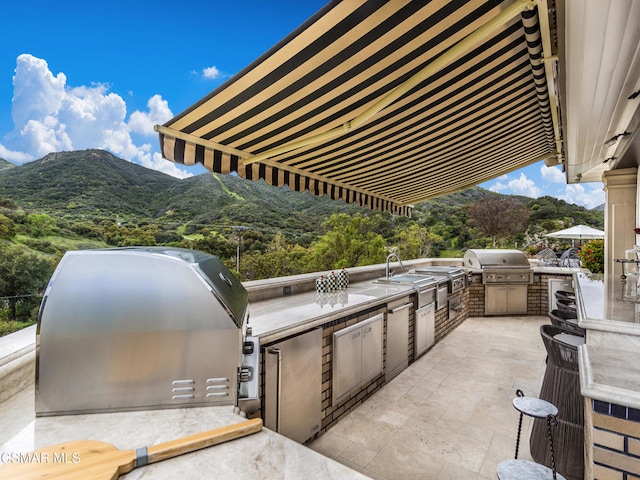 view of patio featuring area for grilling, a mountain view, and grilling area