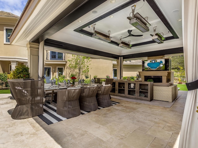 view of patio / terrace featuring ceiling fan and a bar