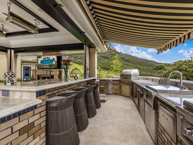 view of patio featuring a mountain view and area for grilling