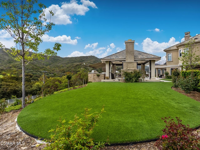 view of yard featuring a gazebo and a mountain view