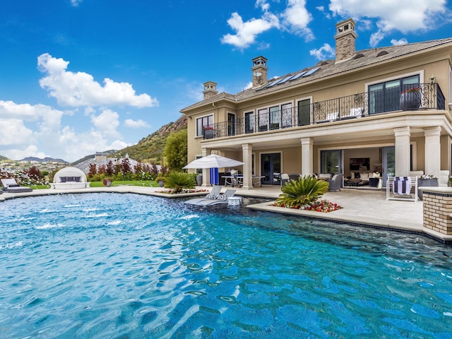 view of pool featuring a patio and a mountain view