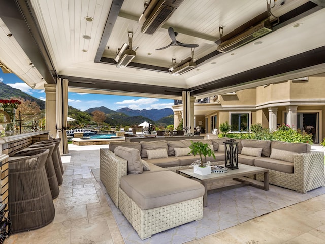 view of patio / terrace featuring an outdoor hangout area, a mountain view, and ceiling fan