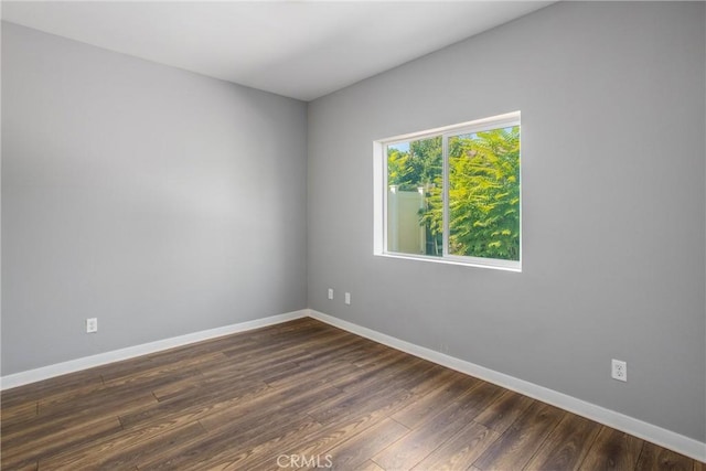 unfurnished room with dark hardwood / wood-style floors