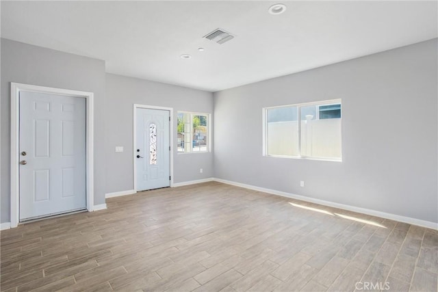 spare room with light hardwood / wood-style floors