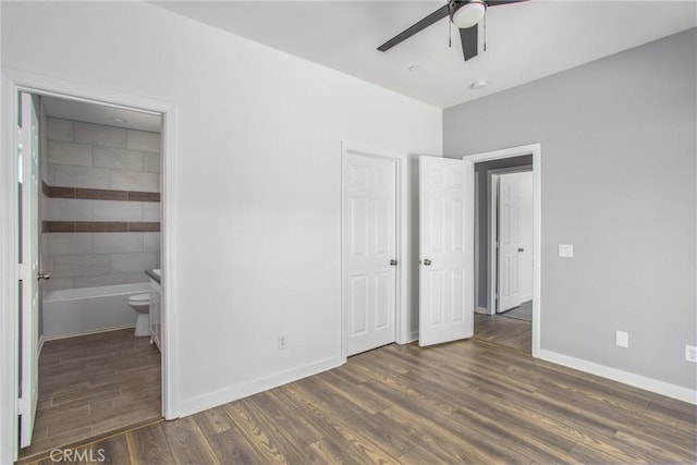 unfurnished bedroom featuring dark hardwood / wood-style floors, ceiling fan, and ensuite bathroom